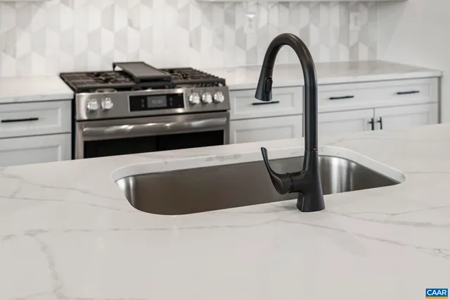 a kitchen with a stove and a white cabinet