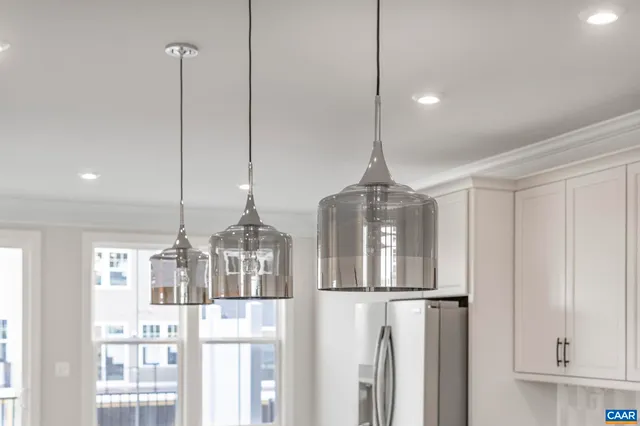 a view of a kitchen with wooden floor and a refrigerator