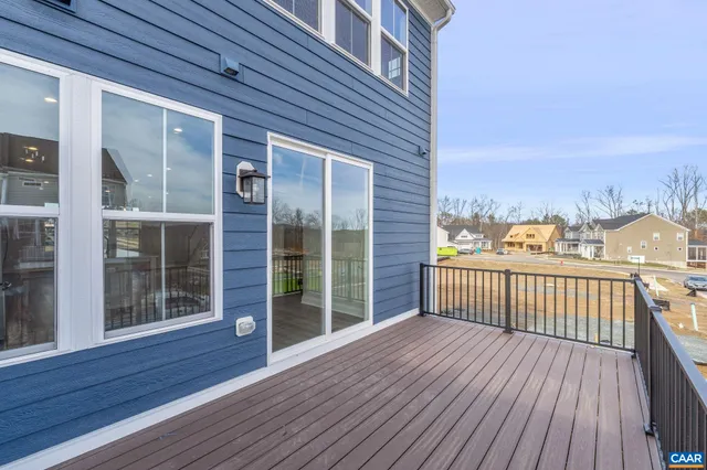 a view of a balcony with wooden floor and city view