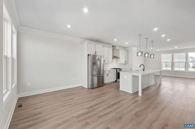 a view of a kitchen with wooden floor and windows