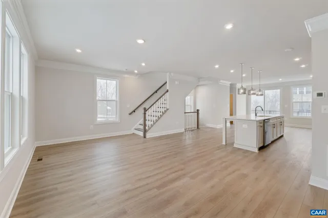 a view of a kitchen with wooden floor and a sink