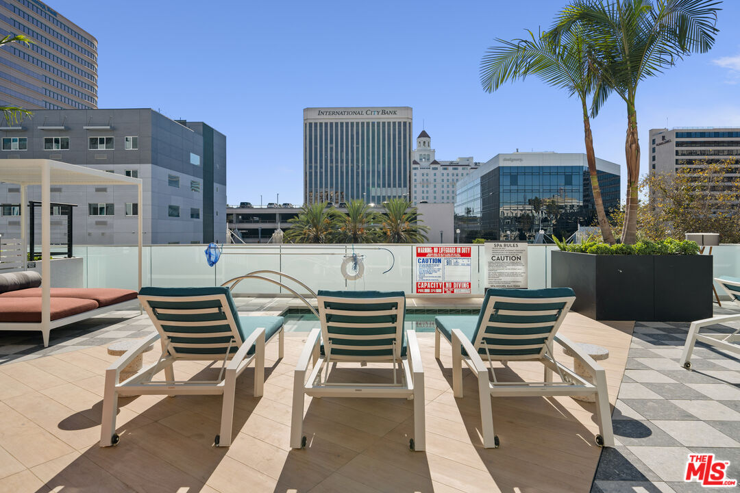 250 East Broadway, Unit 715 Long Beach, CA 90802 - Photo 22 of 44 a roof deck with couches and potted plants