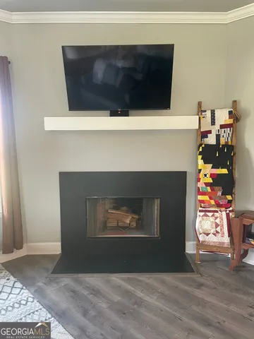 a living room with a fireplace and a wooden floor