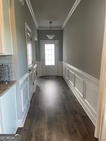a view of entryway and hall with wooden floor