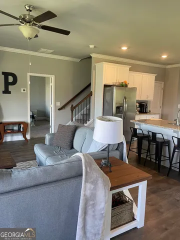 a living room with furniture and a wooden floor