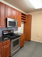 a kitchen with stainless steel appliances a stove a microwave and sink