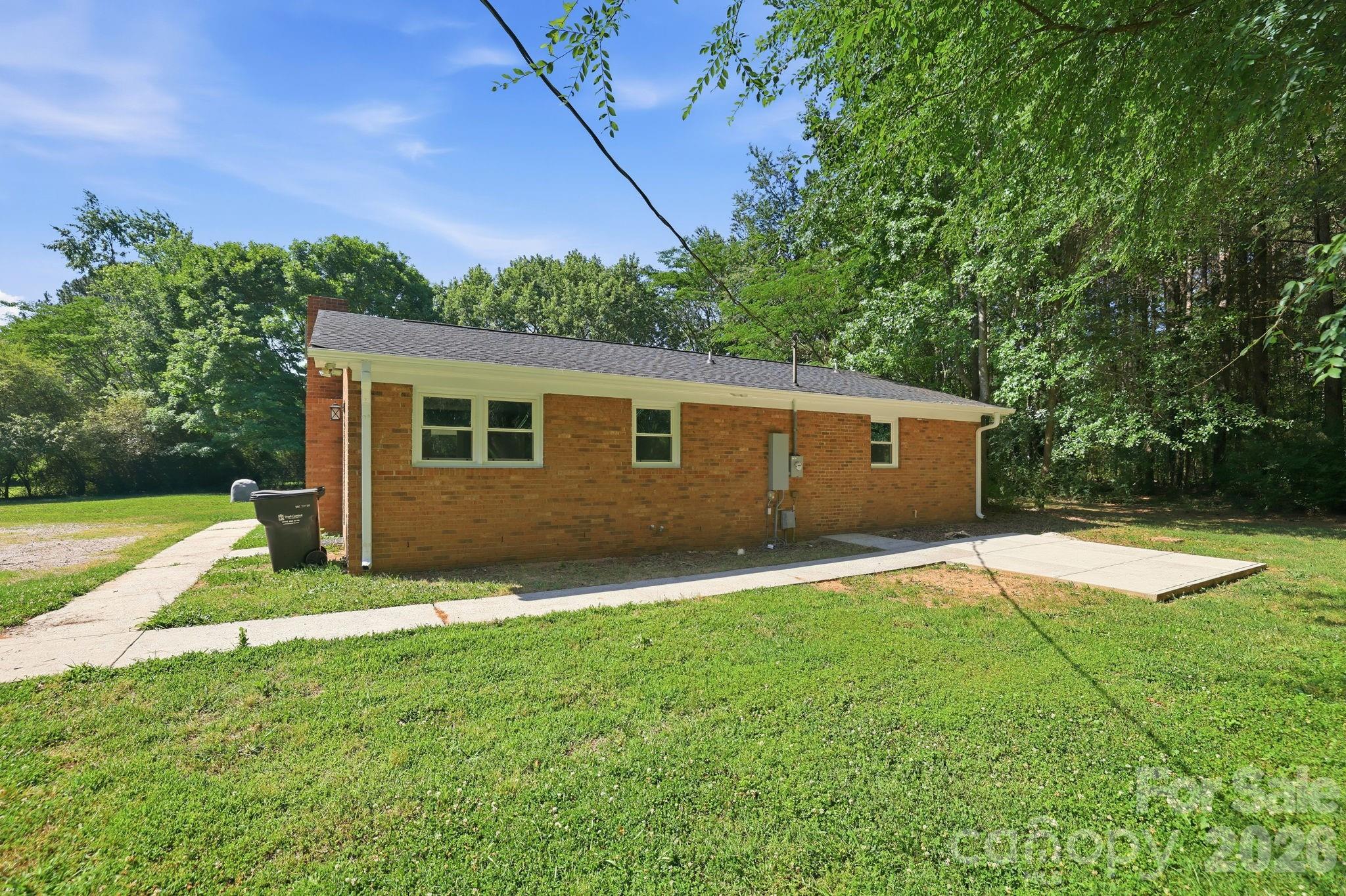 1108 Willoughby Road Monroe, NC 28110 - Photo 24 of 48 a backyard of a house with lots of green space