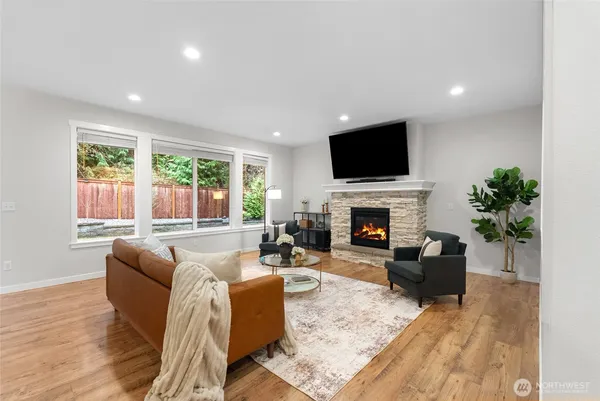 a living room with furniture a flat screen tv and a fireplace