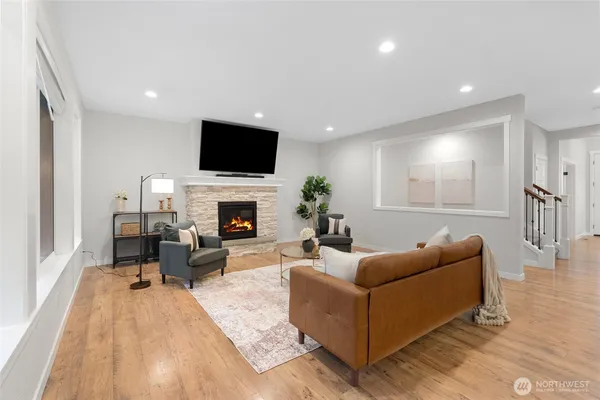 a living room with furniture a flat screen tv and a fireplace