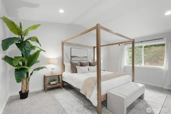 a bedroom with a bed and a potted plant