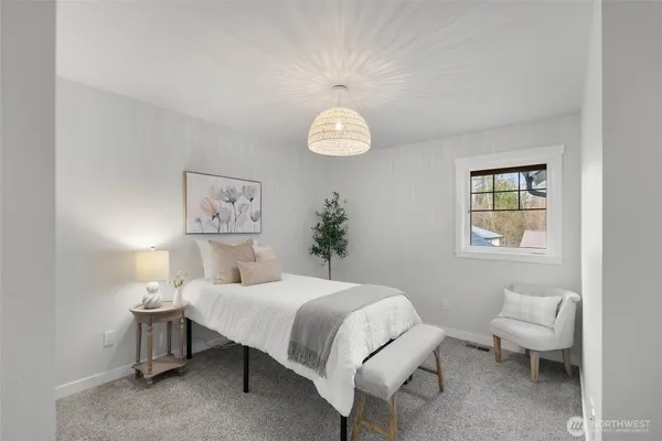a bedroom with a bed and a lamp