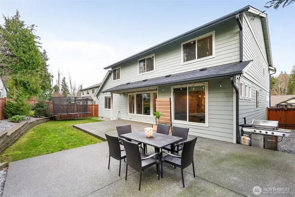 a view of a house with a backyard and sitting area