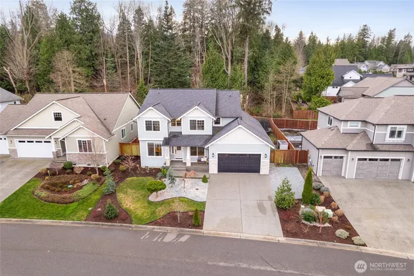 an aerial view of a house with a garden and trees