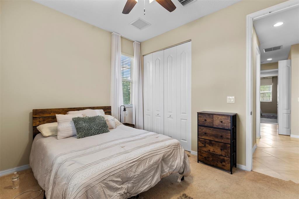 5224 Southwest 77th Way Davie, FL 33328 - Photo 17 of 43 a bedroom with a bed and a chandelier
