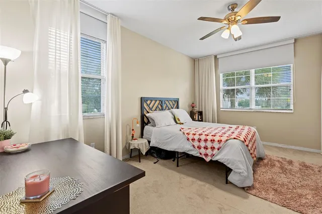 a bed sitting in a bedroom next to a window