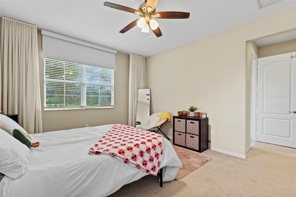 5224 Southwest 77th Way Davie, FL 33328 - Photo 35 of 43 a bedroom with a bed a chandelier and a window