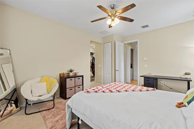 a bedroom with a bed a dresser and chair