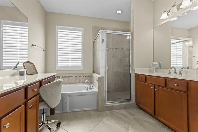 a bathroom with a tub sink and mirror