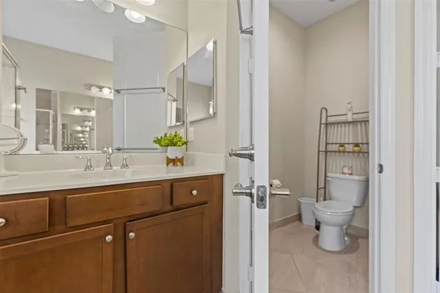 a bathroom with a sink toilet and a mirror