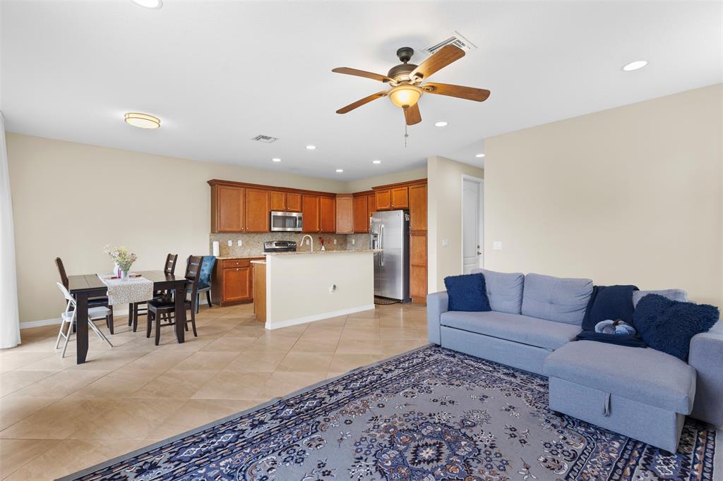 5224 Southwest 77th Way Davie, FL 33328 - Photo 5 of 43 a living room with furniture kitchen view and a chandelier