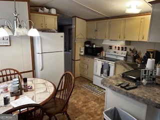 233 Begonia Road Sparta, GA 31087 - Photo 19 of 27 a kitchen with a sink appliances and cabinets