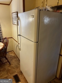 233 Begonia Road Sparta, GA 31087 - Photo 20 of 27 a white refrigerator freezer sitting in a kitchen