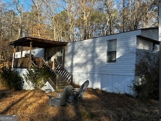 233 Begonia Road Sparta, GA 31087 - Photo 2 of 27 a backyard of a house with table and chairs under an umbrella