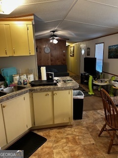 233 Begonia Road Sparta, GA 31087 - Photo 21 of 27 a room with stainless steel appliances kitchen island granite countertop a sink cabinets and wooden floor