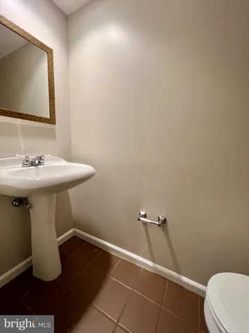 a bathroom with a sink toilet and mirror
