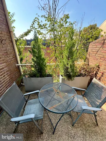 a view of a chairs and table in the patio