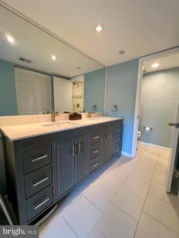 a bathroom with a sink vanity and mirror