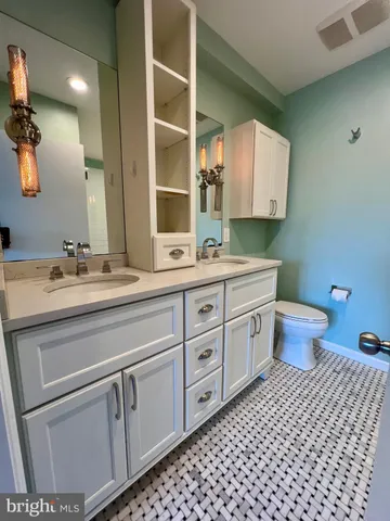 a bathroom with a double vanity sink and a mirror