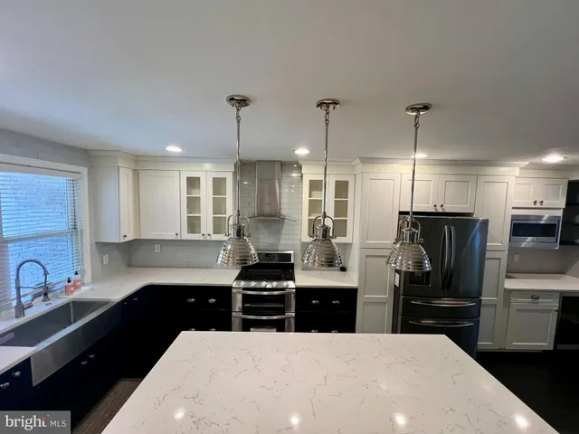 a kitchen with stainless steel appliances a sink stove and refrigerator