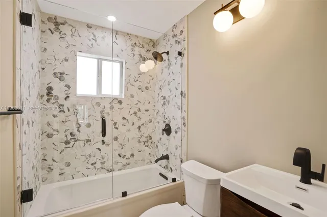 a bathroom with a bathtub and shower