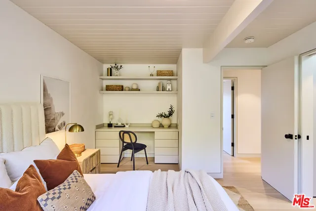 a bedroom with furniture and a wooden floor