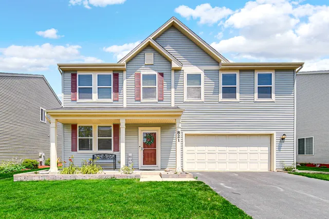 a front view of a house with garden and porch