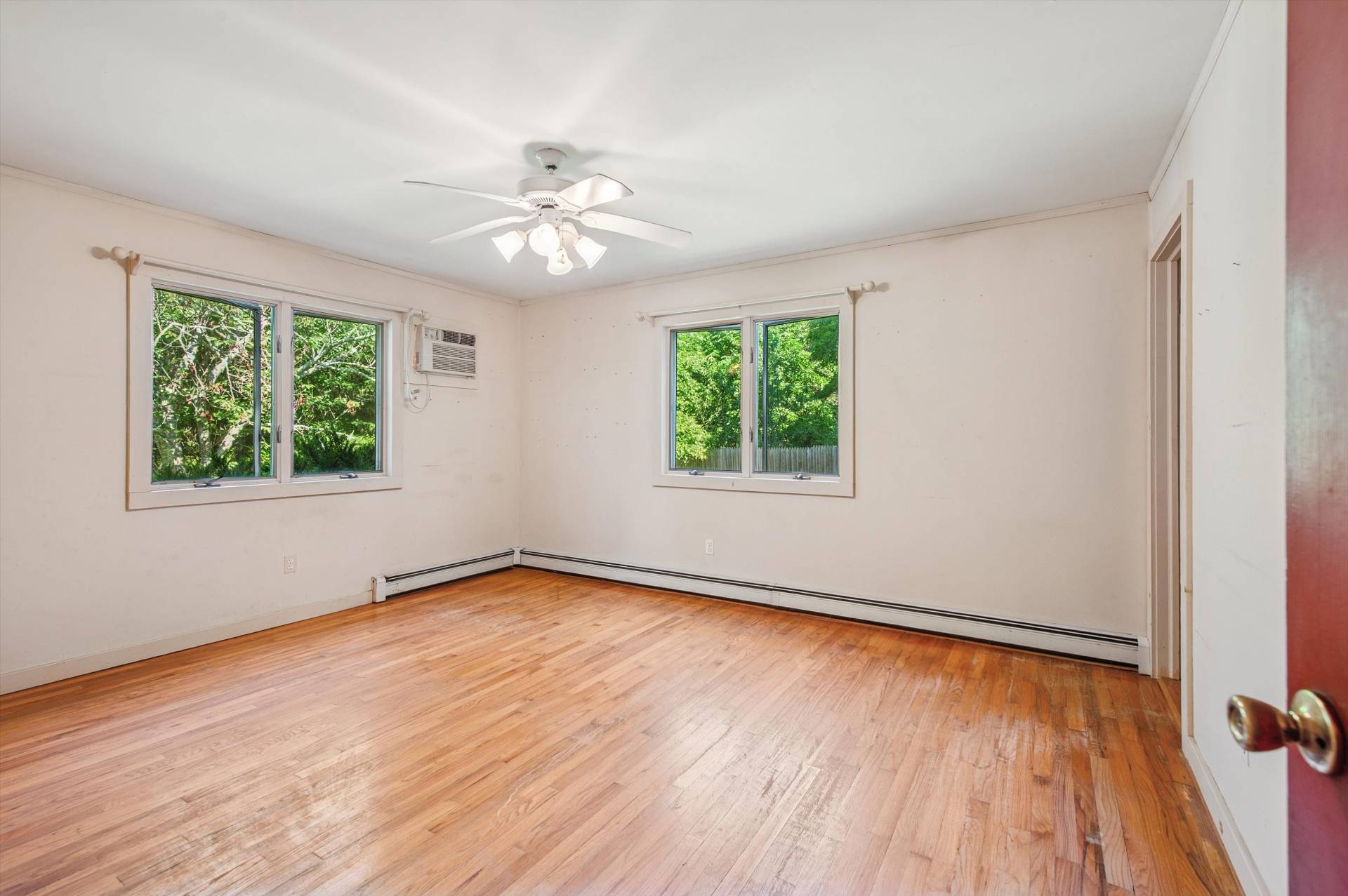 27 Jagger Lane Westhampton, NY 11977 - Photo 8 of 12 a view of an empty room with wooden floor and a window