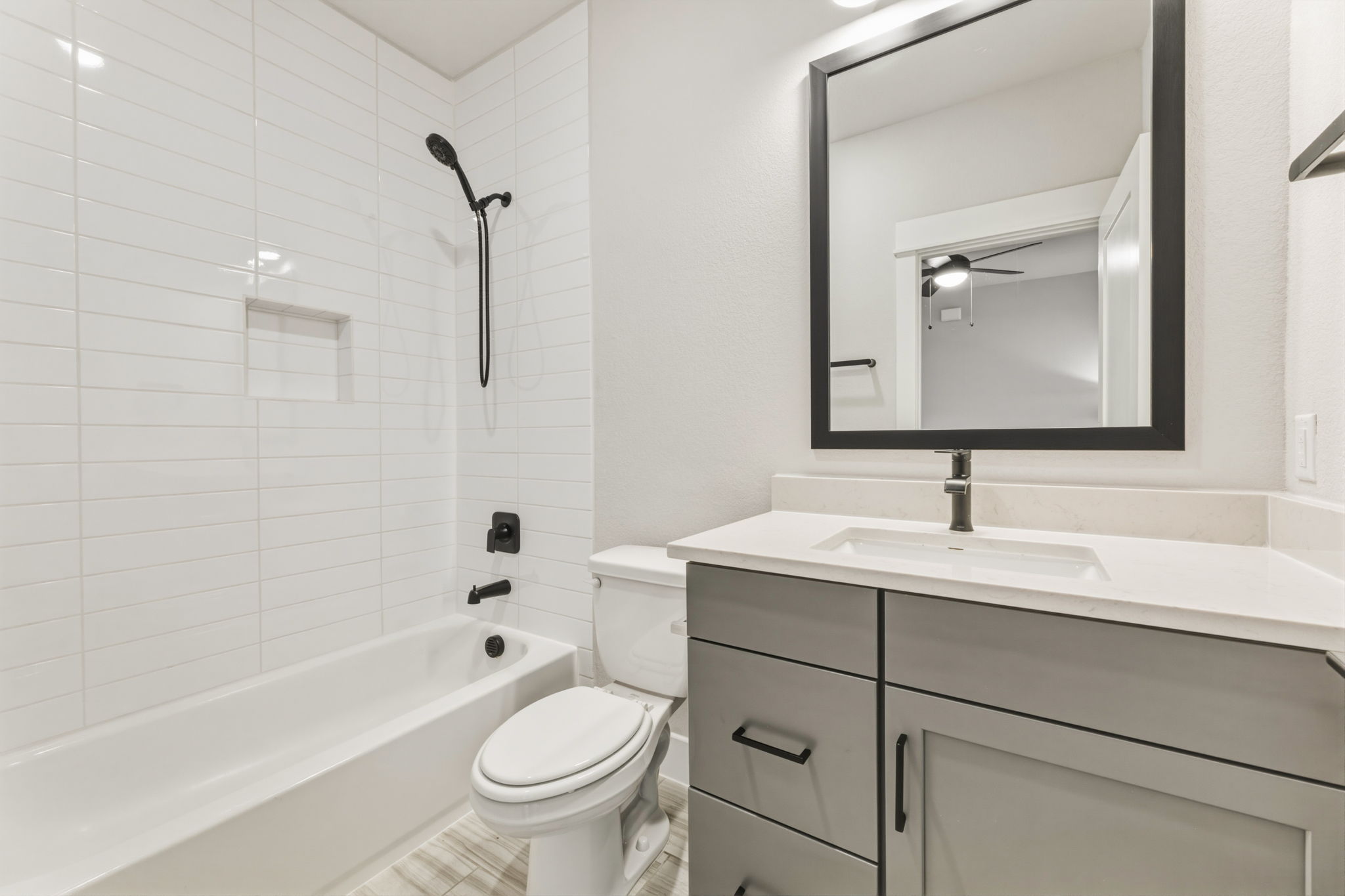 2929 Moreno Street Austin, TX 78723 - Photo 28 of 40 Contemporary bathroom featuring a grey vanity with matte black hardware, a white undermount sink, and a light-toned countertop