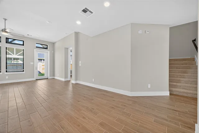 wooden floor in an empty room with a window