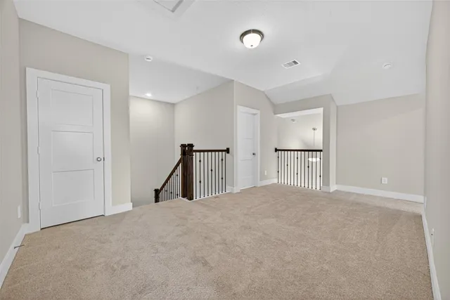 a view of empty room with wooden floor and window