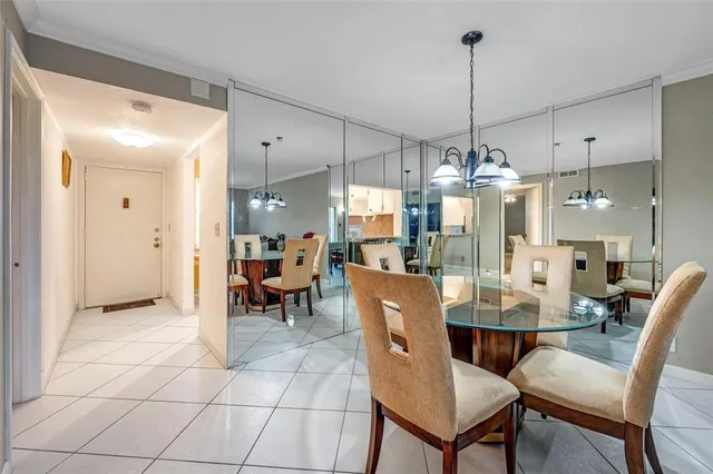 a dining room filled with furniture and a chandelier