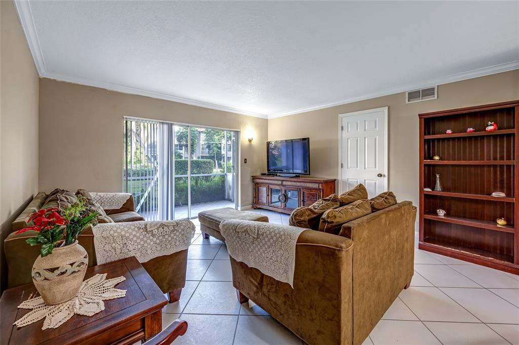3774 Inverrary Boulevard, Unit 104P Fort Lauderdale, FL 33319 - Photo 8 of 22 a living room with furniture and a window