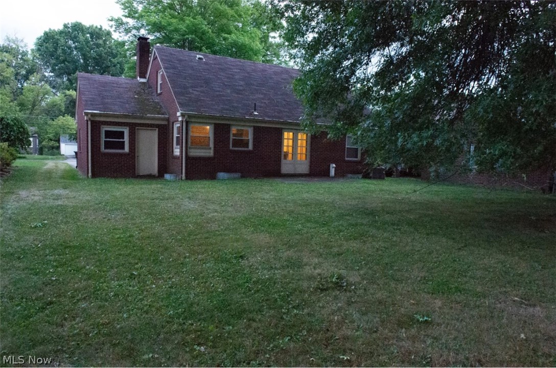 6714 Trenholm Road Youngstown, OH 44512 - Photo 18 of 22 Back of property featuring a lawn