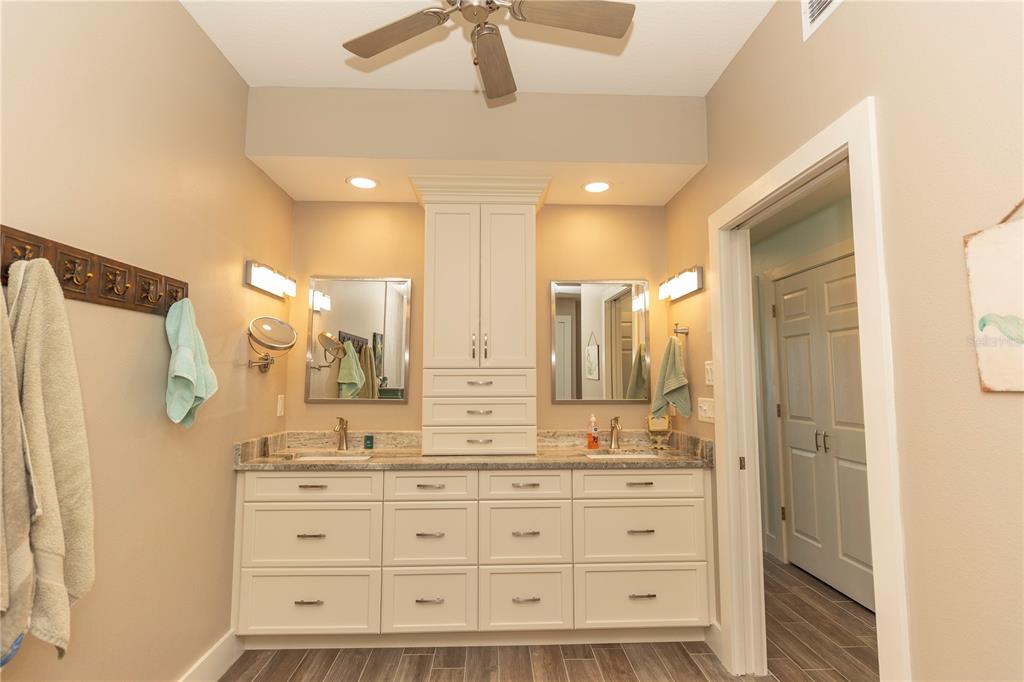 9203 Griggs Road, Unit D302 Englewood, FL 34224 - Photo 32 of 73 a bathroom with a granite countertop sink mirror and double