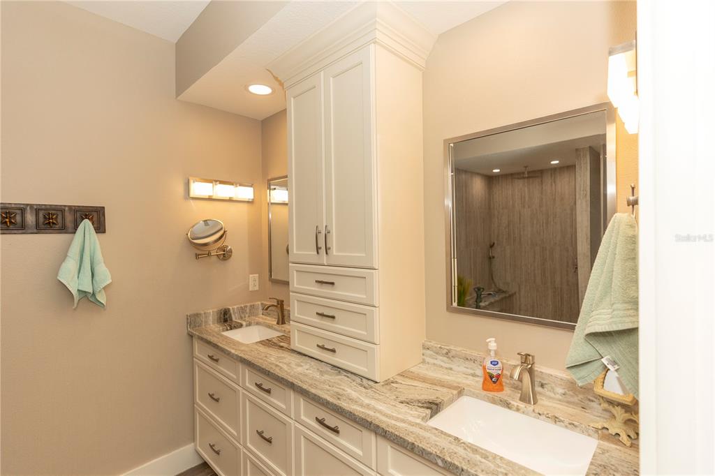9203 Griggs Road, Unit D302 Englewood, FL 34224 - Photo 35 of 73 a bathroom with a sink vanity and mirror