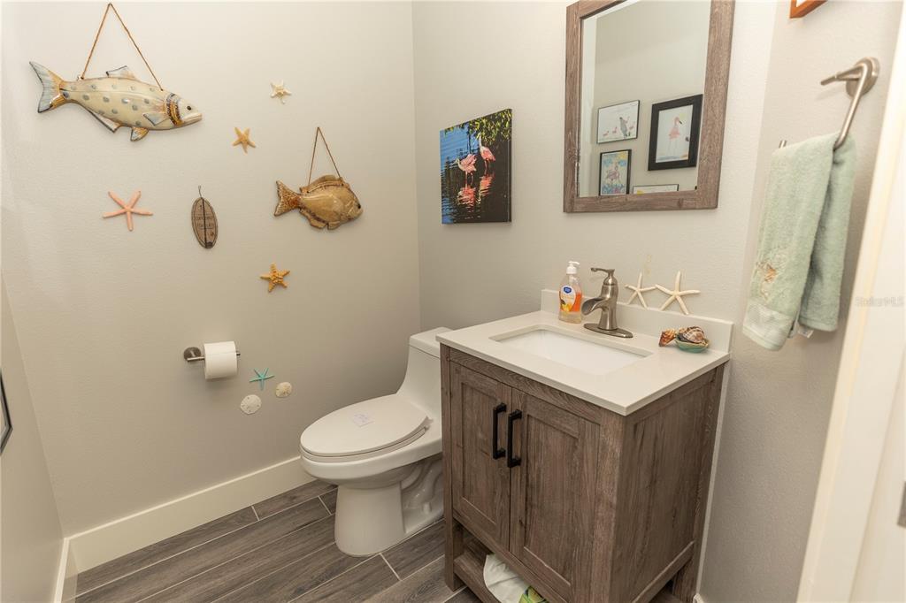 9203 Griggs Road, Unit D302 Englewood, FL 34224 - Photo 40 of 73 a bathroom with a sink a toilet and mirror