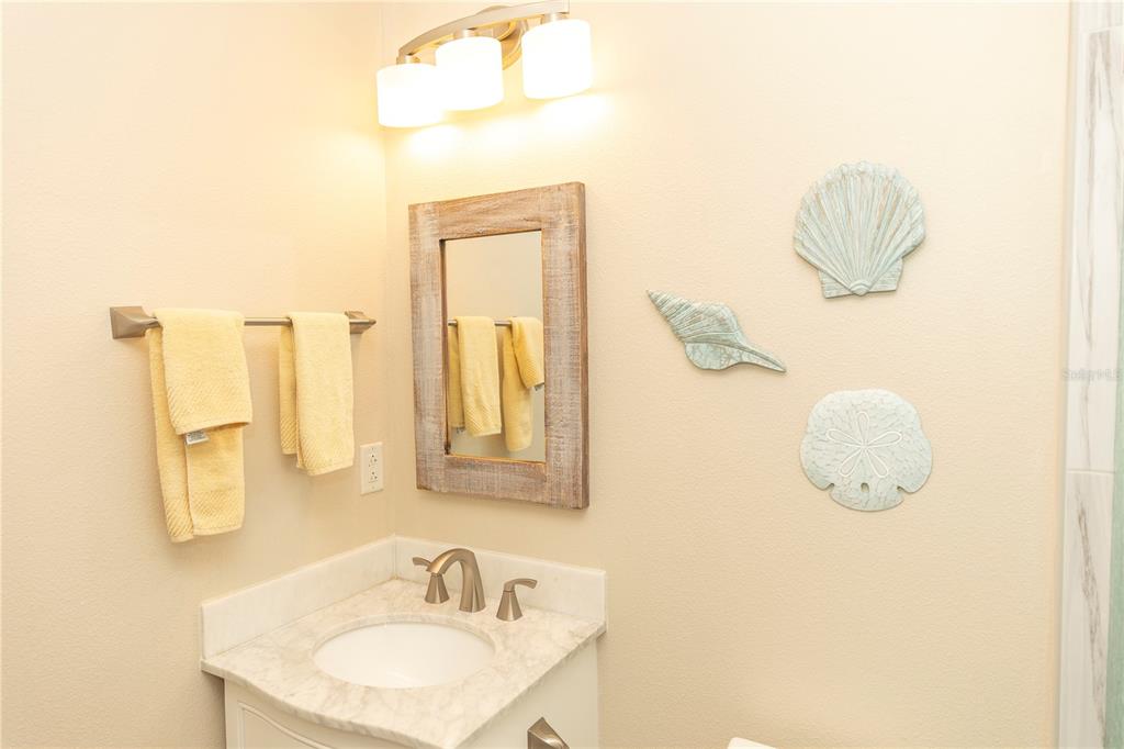 9203 Griggs Road, Unit D302 Englewood, FL 34224 - Photo 41 of 73 a bathroom with a sink a mirror and vanity