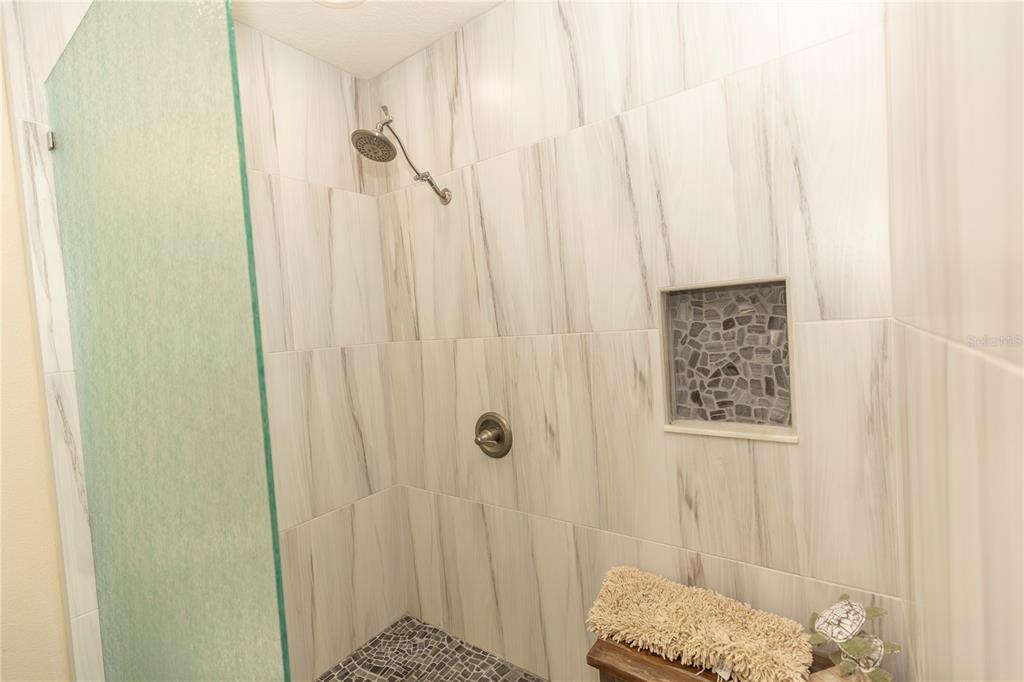 9203 Griggs Road, Unit D302 Englewood, FL 34224 - Photo 43 of 73 a bathroom with a shower curtain and a window