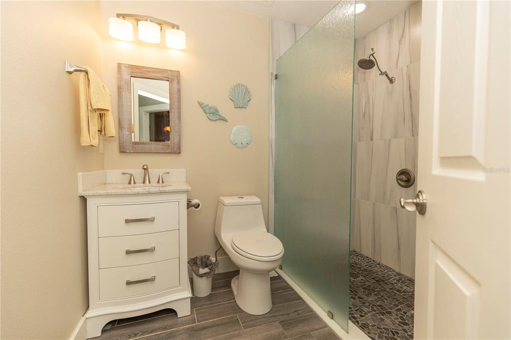 9203 Griggs Road, Unit D302 Englewood, FL 34224 - Photo 45 of 73 a bathroom with a sink a toilet and shower