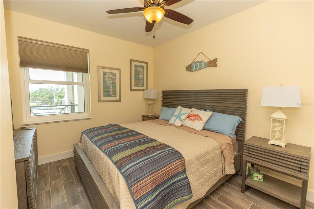 9203 Griggs Road, Unit D302 Englewood, FL 34224 - Photo 48 of 73 a bedroom with a bed and a chandelier